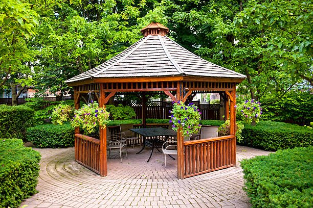 Gazebo in landscaped garden with interlocking stone patio